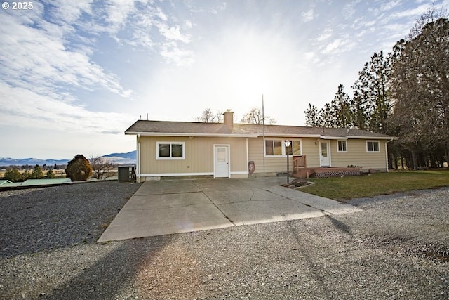 single story home with central AC unit and a mountain view