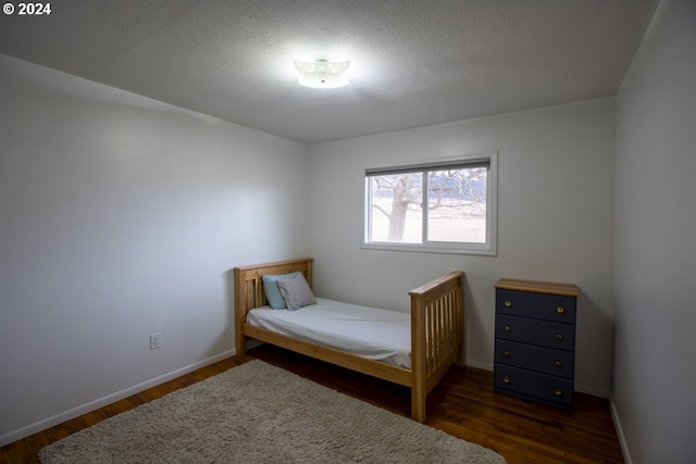 bedroom featuring dark wood-type flooring