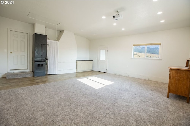 unfurnished living room featuring light colored carpet