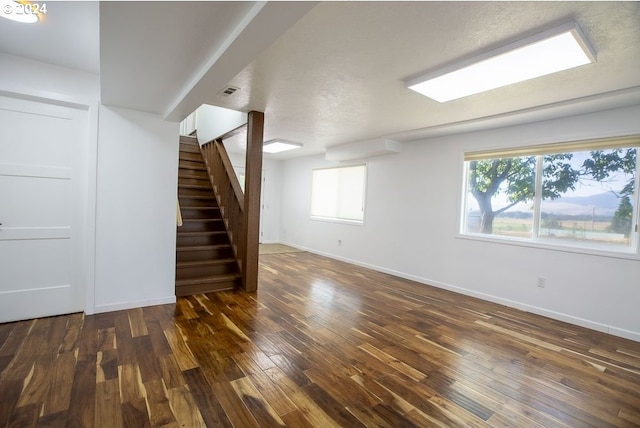 interior space featuring a healthy amount of sunlight and dark hardwood / wood-style flooring