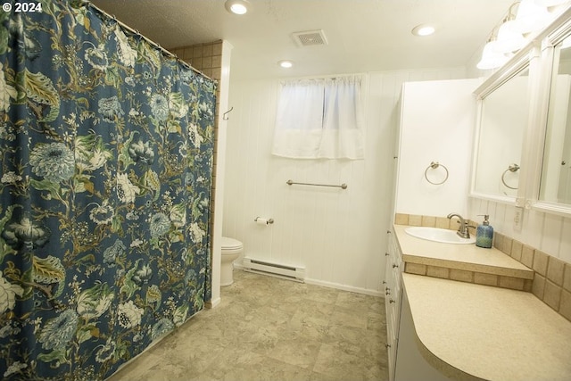 bathroom with wooden walls, toilet, vanity, and a baseboard heating unit