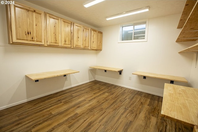 clothes washing area with dark hardwood / wood-style floors