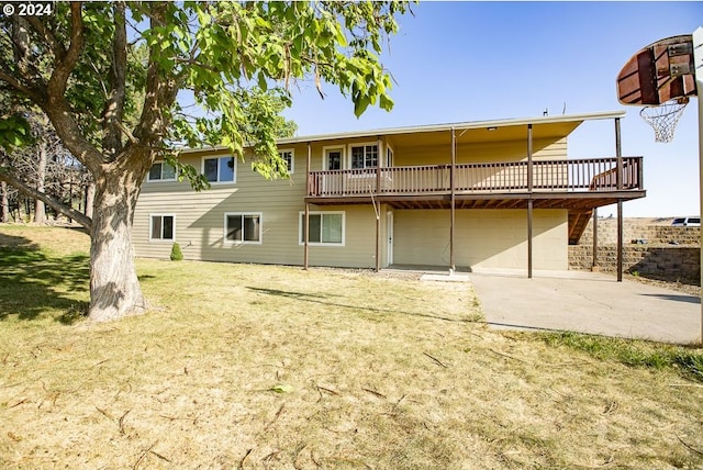 rear view of house featuring a patio area, a yard, and a wooden deck