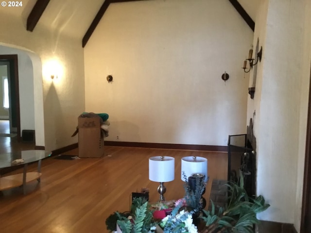 corridor featuring vaulted ceiling with beams and hardwood / wood-style flooring