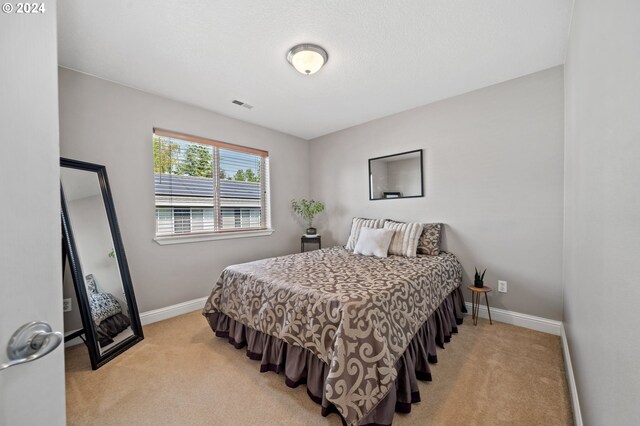 carpeted bedroom featuring lofted ceiling