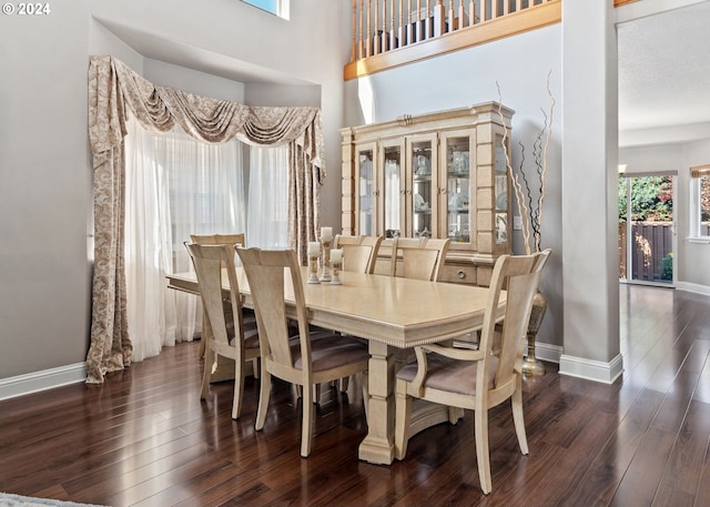 dining space with dark hardwood / wood-style flooring