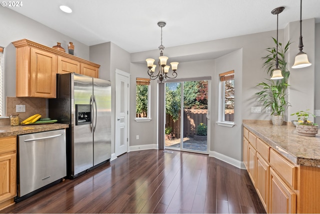 kitchen with pendant lighting, appliances with stainless steel finishes, dark hardwood / wood-style floors, and tasteful backsplash