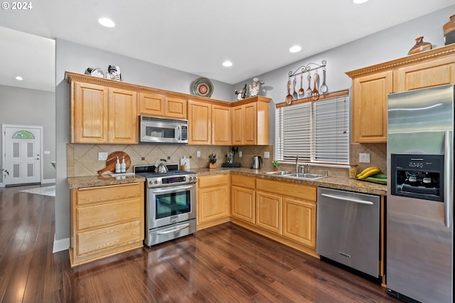 kitchen featuring appliances with stainless steel finishes, sink, light brown cabinets, and dark hardwood / wood-style floors