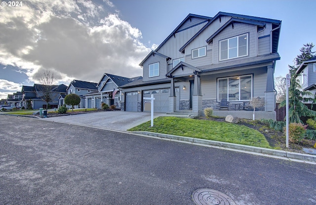 craftsman-style home featuring a porch, a garage, and a front lawn