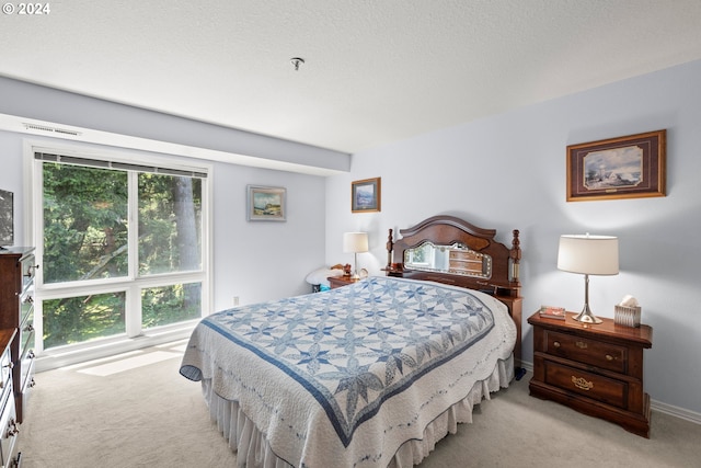 bedroom with multiple windows and light carpet