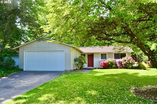 ranch-style home featuring a garage and a front yard