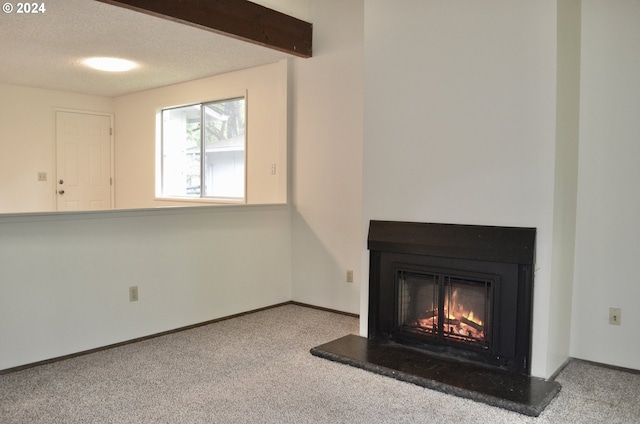 interior details with beam ceiling, carpet floors, and a textured ceiling