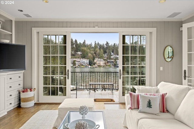 interior space with plenty of natural light, light hardwood / wood-style floors, and ornamental molding