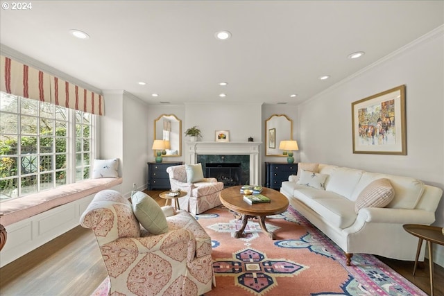 living room featuring a high end fireplace, hardwood / wood-style floors, and crown molding