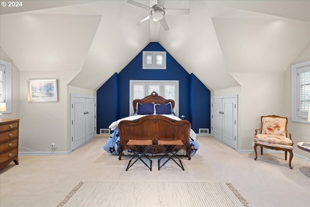 bedroom with light carpet, lofted ceiling, and ceiling fan