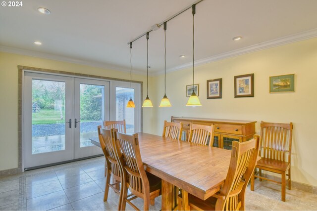 tiled dining room with french doors, crown molding, and track lighting