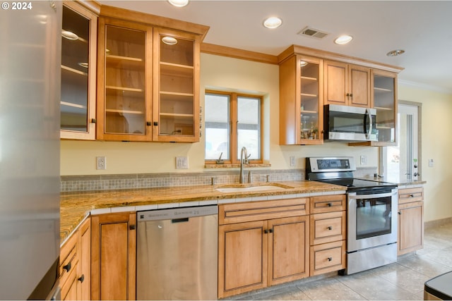 kitchen featuring ornamental molding, stainless steel appliances, sink, tasteful backsplash, and light tile flooring