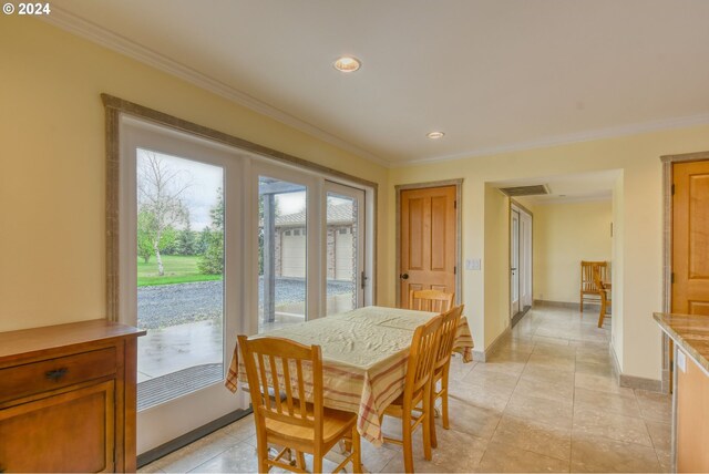 dining area with crown molding and light tile floors