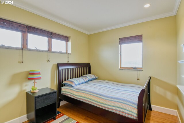 bedroom featuring hardwood / wood-style flooring and ornamental molding