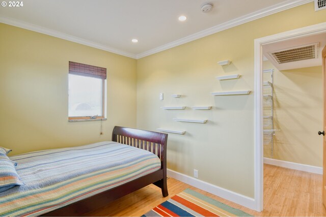 bedroom featuring hardwood / wood-style flooring and crown molding