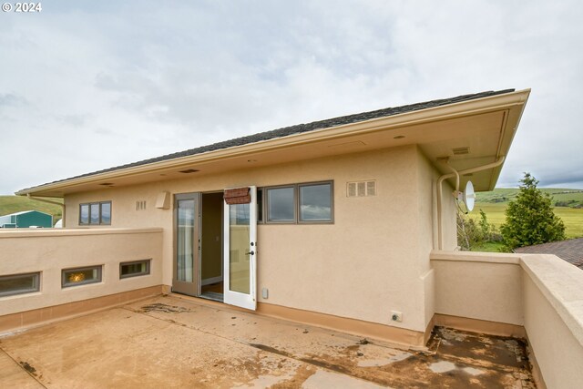 back of property with a patio