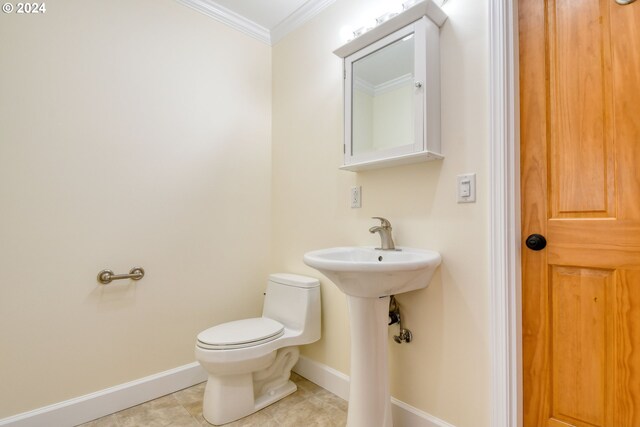 bathroom with tile flooring, ornamental molding, and toilet