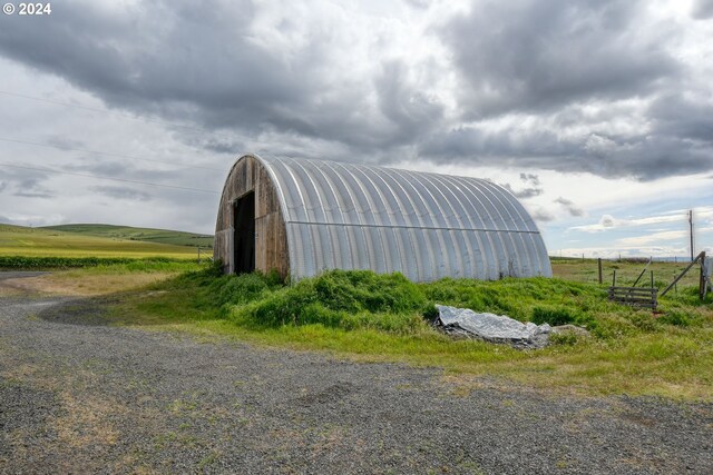 view of shed / structure featuring a rural view