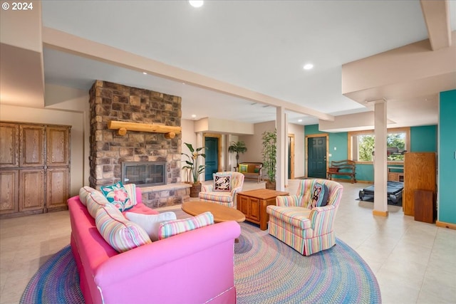 living room featuring light tile flooring and a stone fireplace