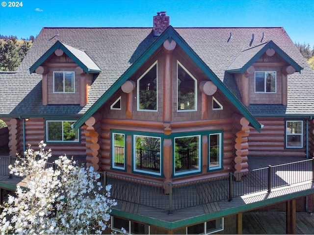 back of property featuring a wooden deck