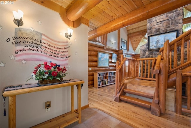 stairway featuring beamed ceiling, tile floors, and rustic walls