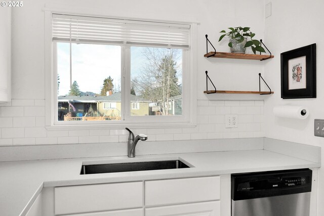 kitchen with sink, white cabinetry, dishwasher, and decorative backsplash