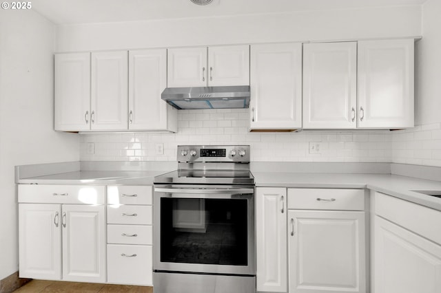 kitchen with white cabinets, tasteful backsplash, and stainless steel electric range oven