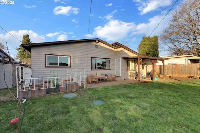 rear view of house with a patio and a lawn