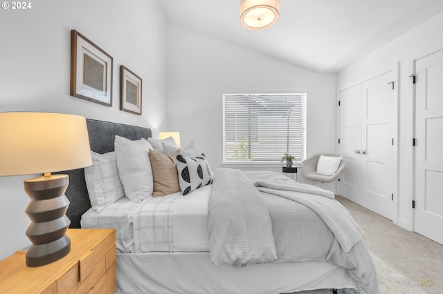 bedroom with carpet flooring and lofted ceiling