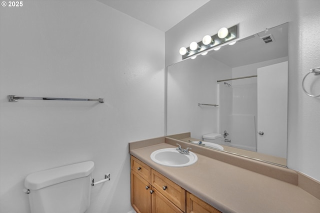 bathroom with vanity, toilet, and walk in shower