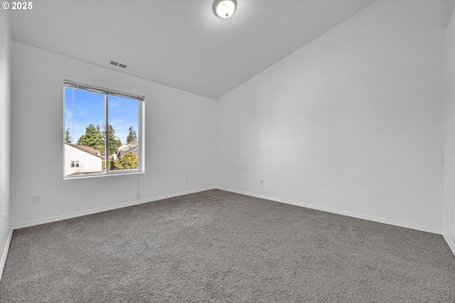 spare room with lofted ceiling and carpet flooring