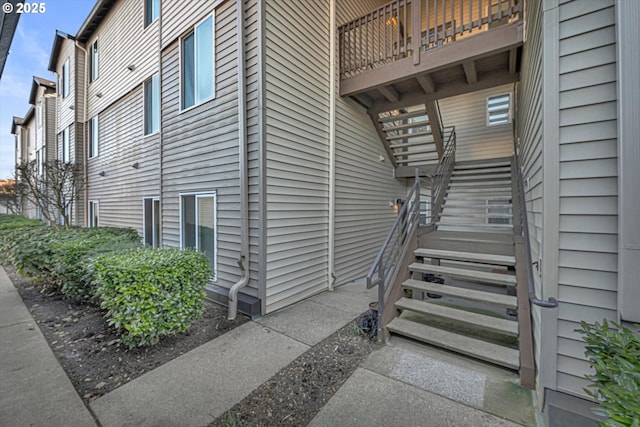 view of exterior entry featuring a balcony