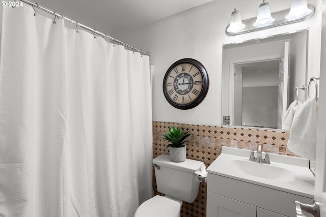 bathroom featuring vanity, toilet, and tasteful backsplash