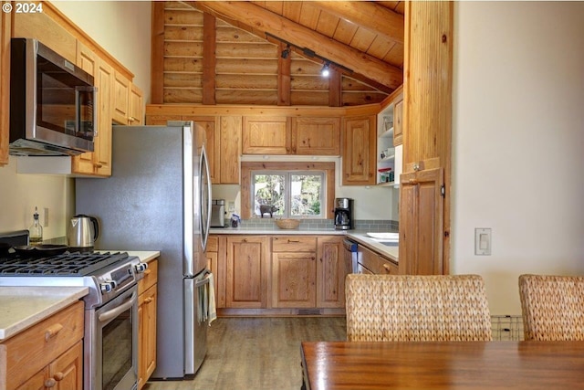 kitchen featuring stainless steel appliances, light hardwood / wood-style floors, wooden ceiling, and lofted ceiling with beams