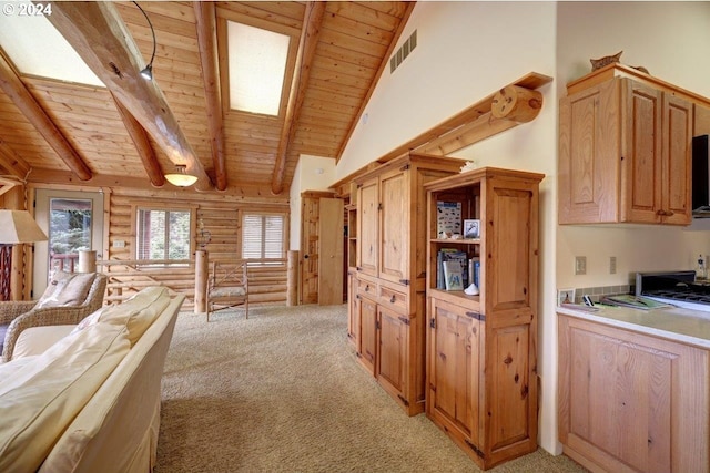 interior space featuring a skylight, beamed ceiling, wooden ceiling, light colored carpet, and log walls