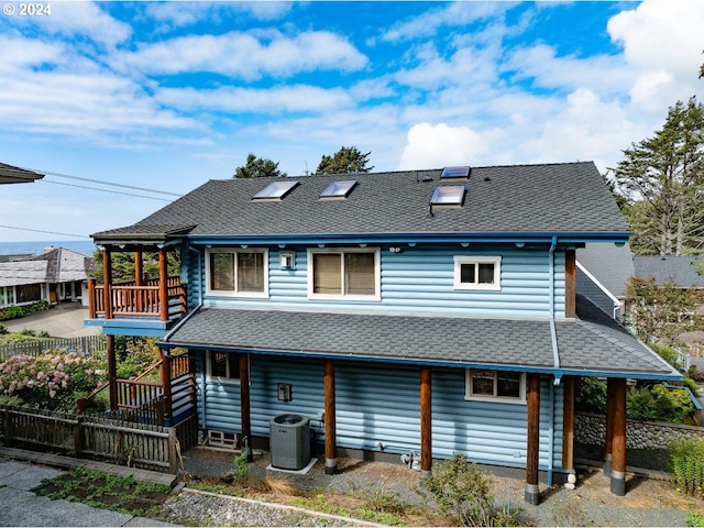 rear view of property featuring central AC