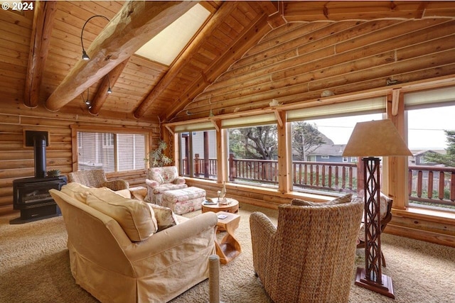 living room featuring a wood stove, plenty of natural light, rustic walls, and vaulted ceiling with skylight