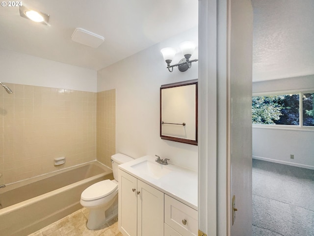 full bathroom featuring toilet, tiled shower / bath combo, and vanity