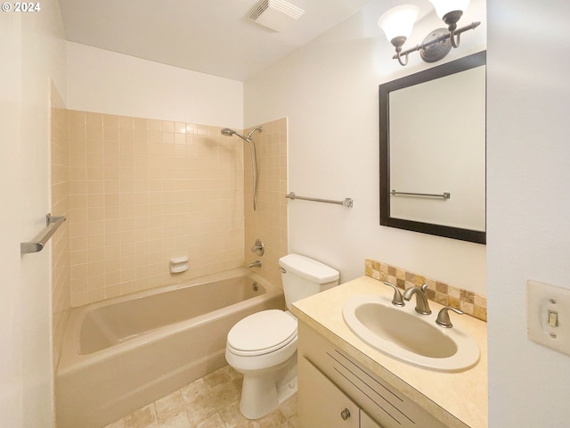 full bathroom with tiled shower / bath, vanity, and toilet