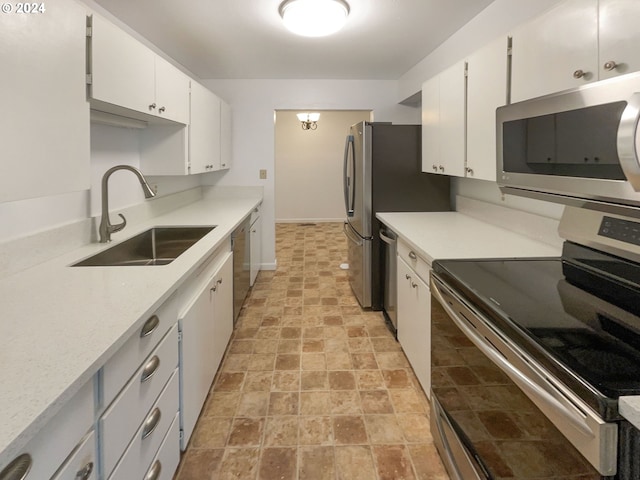 kitchen with white cabinets, appliances with stainless steel finishes, and sink