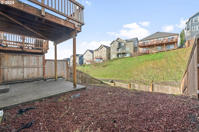 view of yard with a deck and a patio