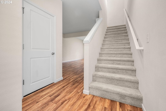 stairs with hardwood / wood-style floors