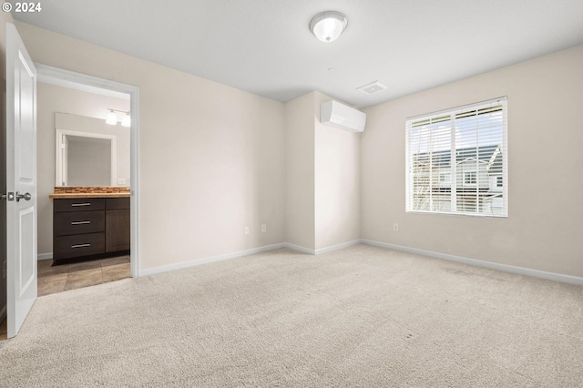 unfurnished room featuring light colored carpet and a wall mounted air conditioner