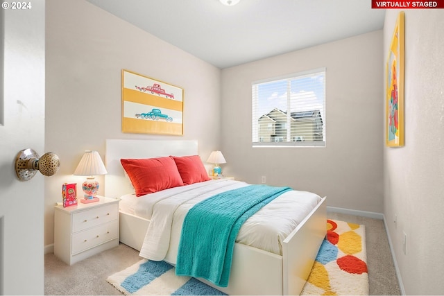 bedroom featuring light colored carpet