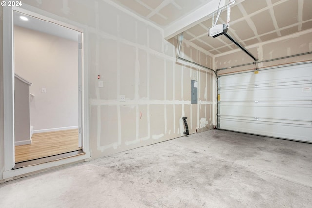 garage with electric panel and a garage door opener